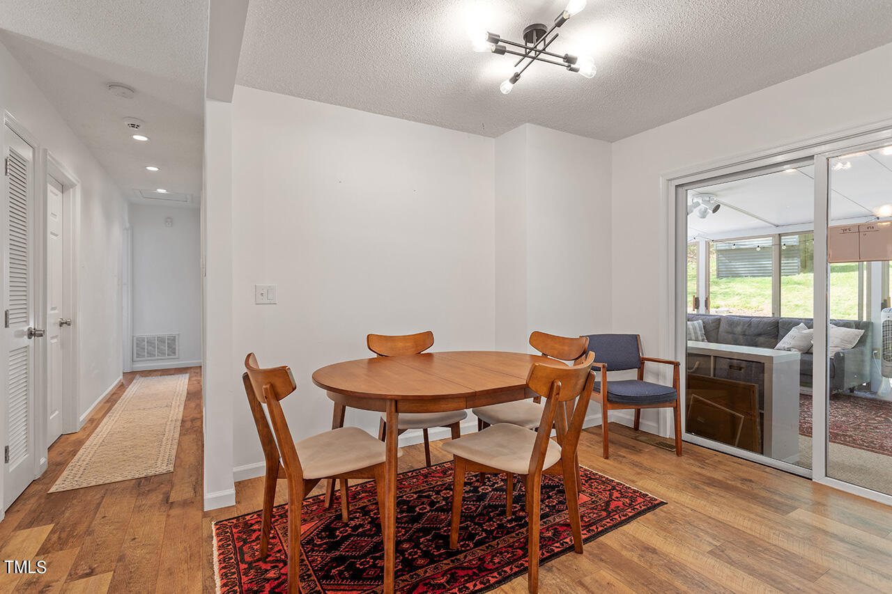 2220 Foxtrot Road Raleigh, NC 27610 - Photo 13 of 24 a dining room with furniture and wooden floor