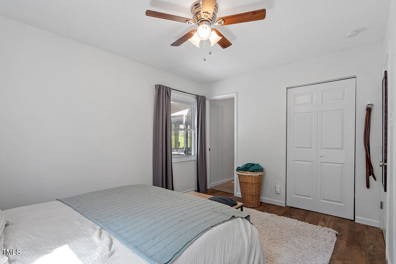 2220 Foxtrot Road Raleigh, NC 27610 - Photo 15 of 24 a bedroom with a bed and a chandelier