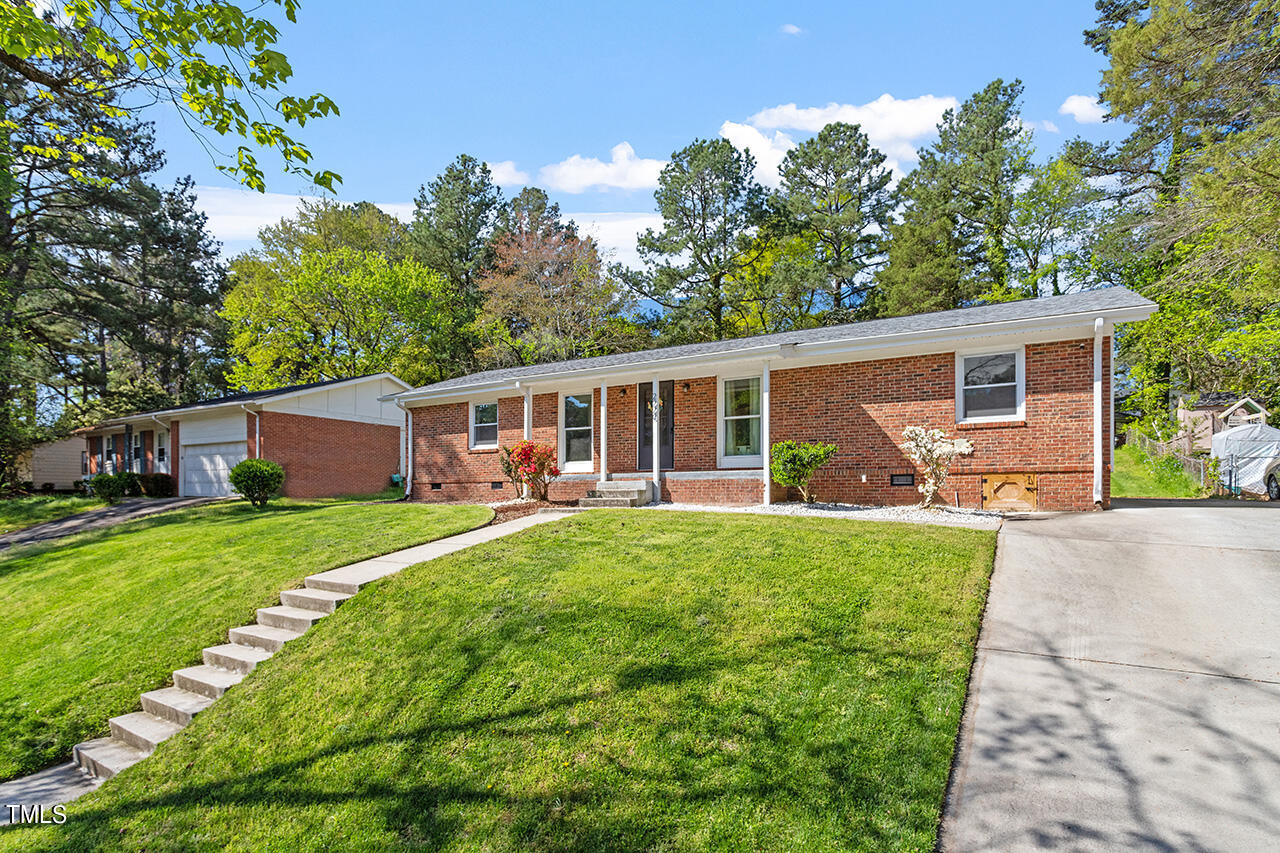 2220 Foxtrot Road Raleigh, NC 27610 - Photo 2 of 24 a front view of house with a garden and patio