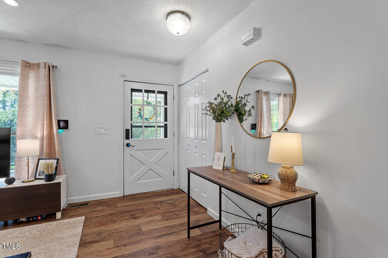 2220 Foxtrot Road Raleigh, NC 27610 - Photo 7 of 24 a view of a livingroom with furniture and wooden floor