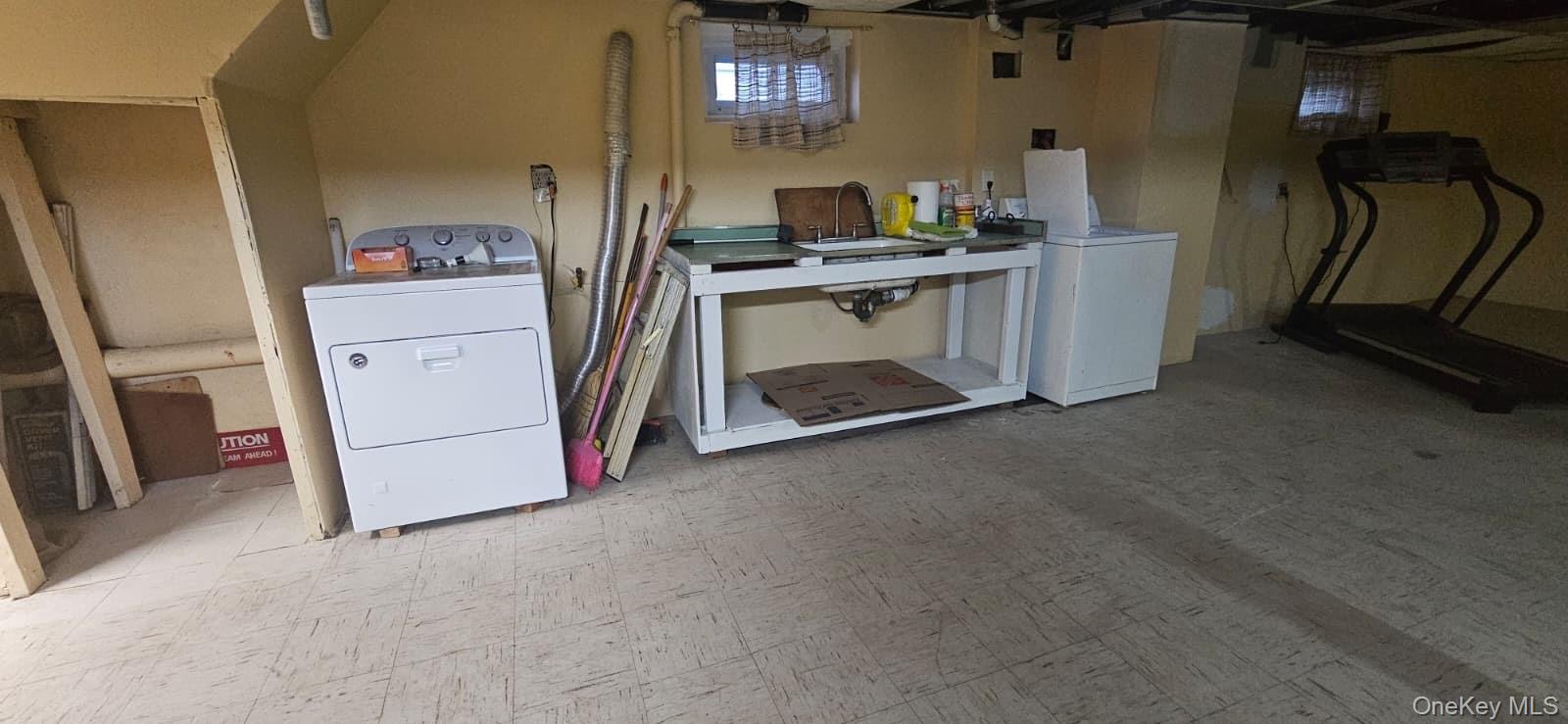 138-39 227th Street Queens, NY 11413 - Photo 21 of 25 a view of a storage and utility room with washer and dryer