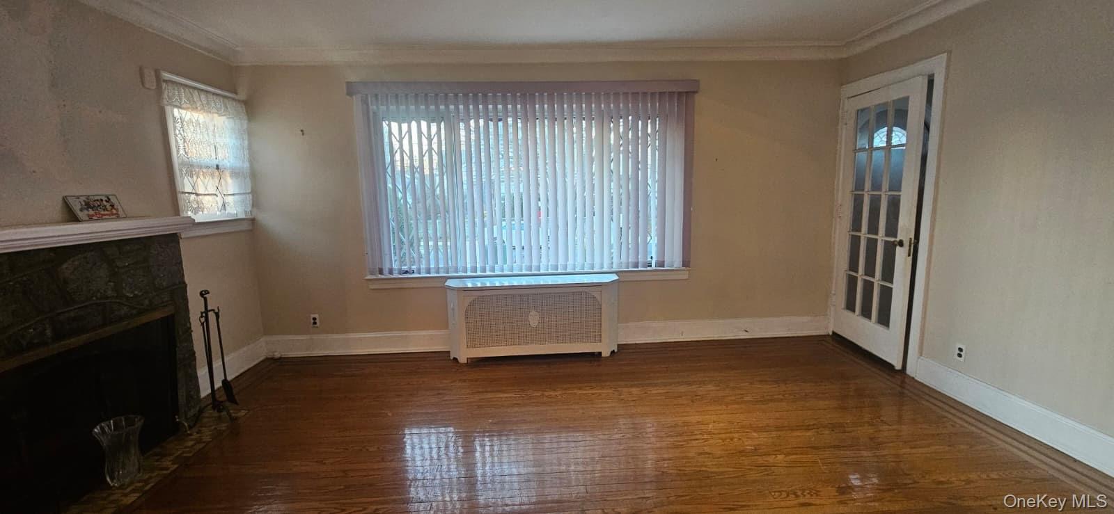 138-39 227th Street Queens, NY 11413 - Photo 4 of 25 an empty room with windows