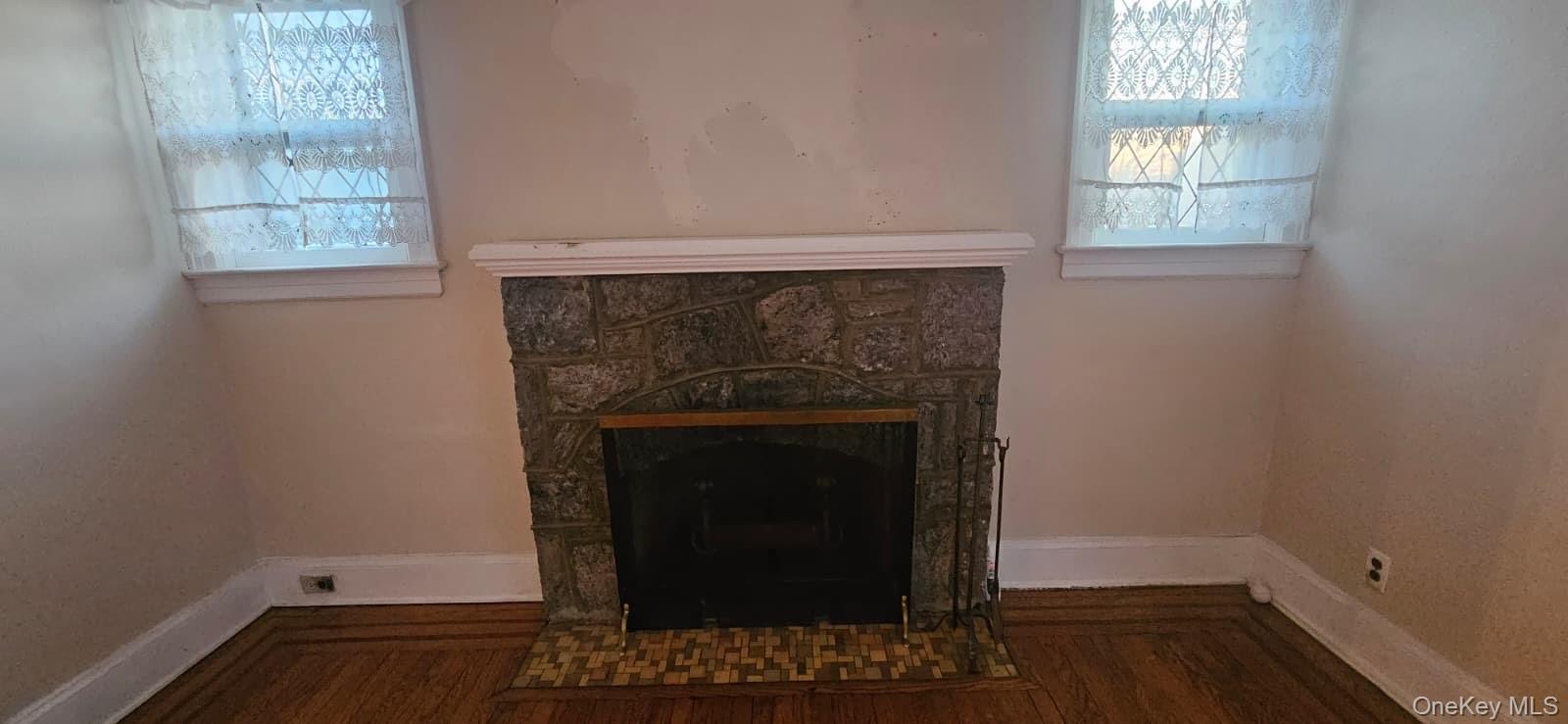 138-39 227th Street Queens, NY 11413 - Photo 5 of 25 a room with a fireplace and a window