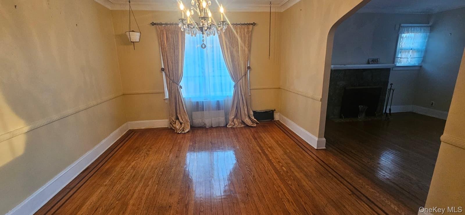 138-39 227th Street Queens, NY 11413 - Photo 6 of 25 a view of a room with wooden floor and staircase