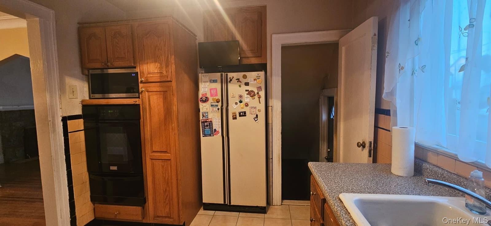 138-39 227th Street Queens, NY 11413 - Photo 8 of 25 a bathroom with a granite countertop sink and a mirror