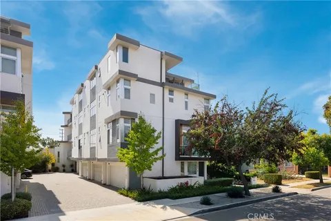 a front view of a building with tree s
