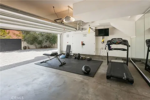 a room with gym equipment and a large window