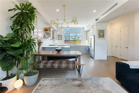 a living room with furniture potted plant and a wooden floor