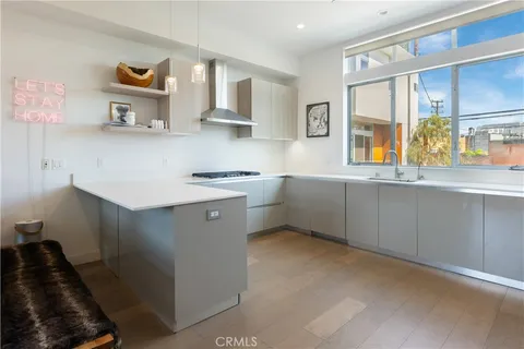 a kitchen with stainless steel appliances a sink stove and cabinets