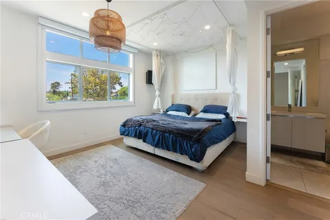 a bedroom with a bed and a painting on the wall