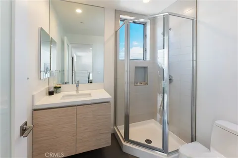 a bathroom with a shower sink and mirror