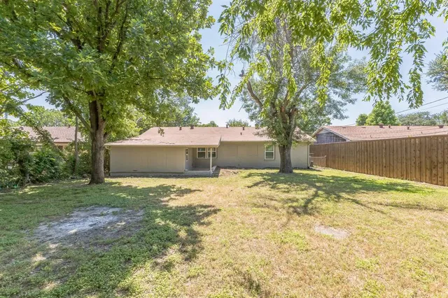 a house with a trees in the background
