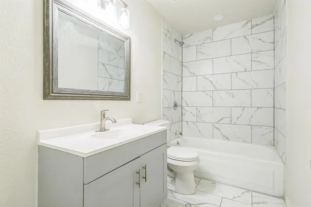 a bathroom with a sink a toilet and bathtub