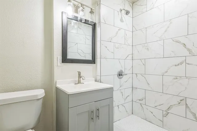 a bathroom with a sink toilet and vanity