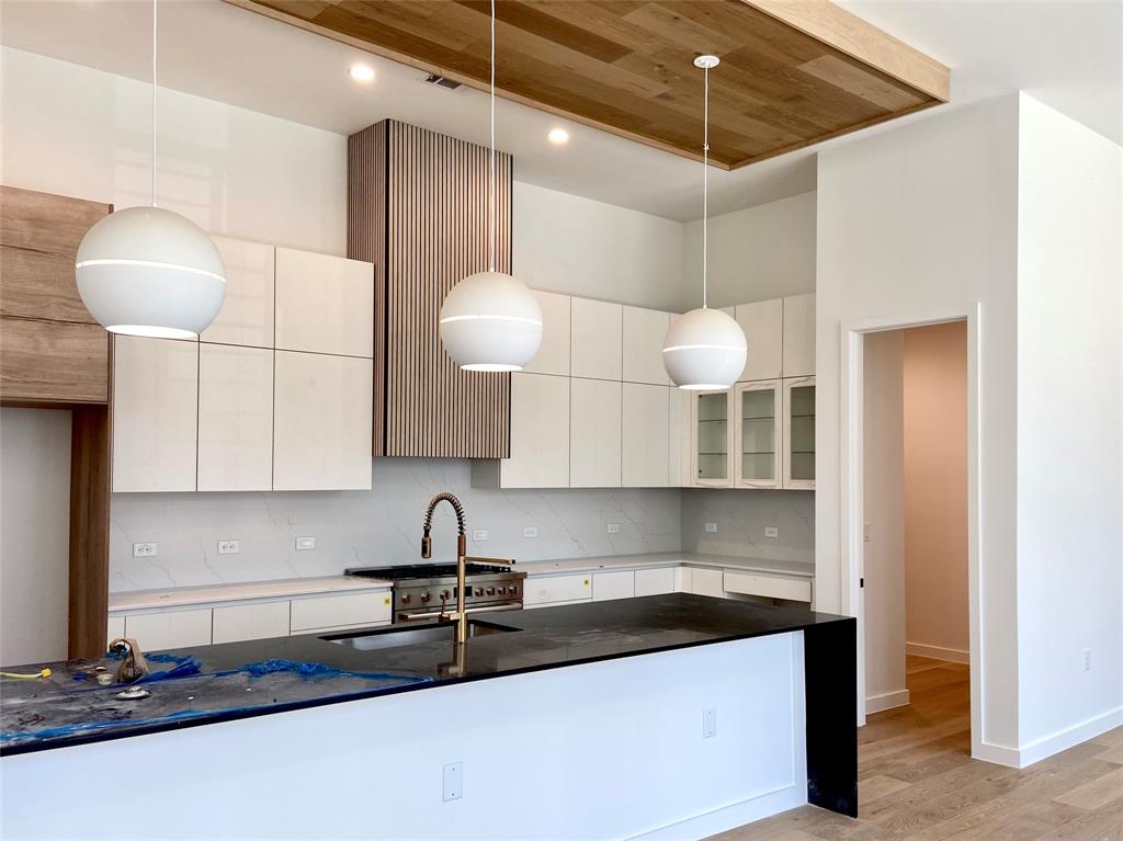 1111 Raiford Road, Unit 128 Carrollton, TX 75007 - Photo 9 of 18 Two tone cabinets, oversized pendants, wood features, and a large walk-in pantry. (construction photos - professional photos upon completion)