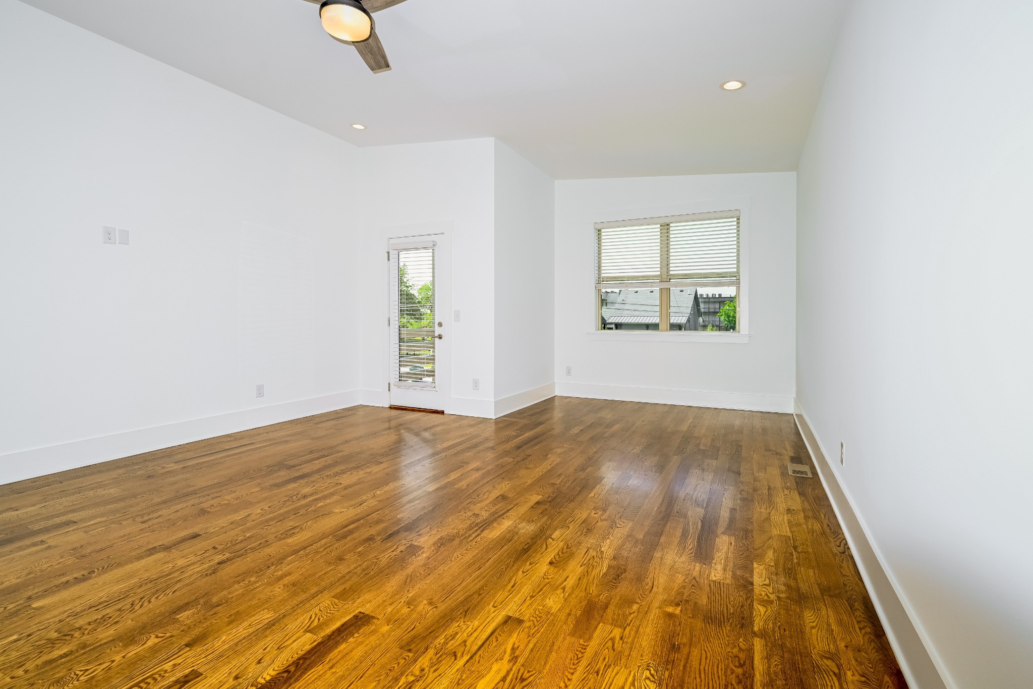 341 Edwin Street, Unit B Nashville, TN 37207 - Photo 13 of 17 an empty room with wooden floor and windows