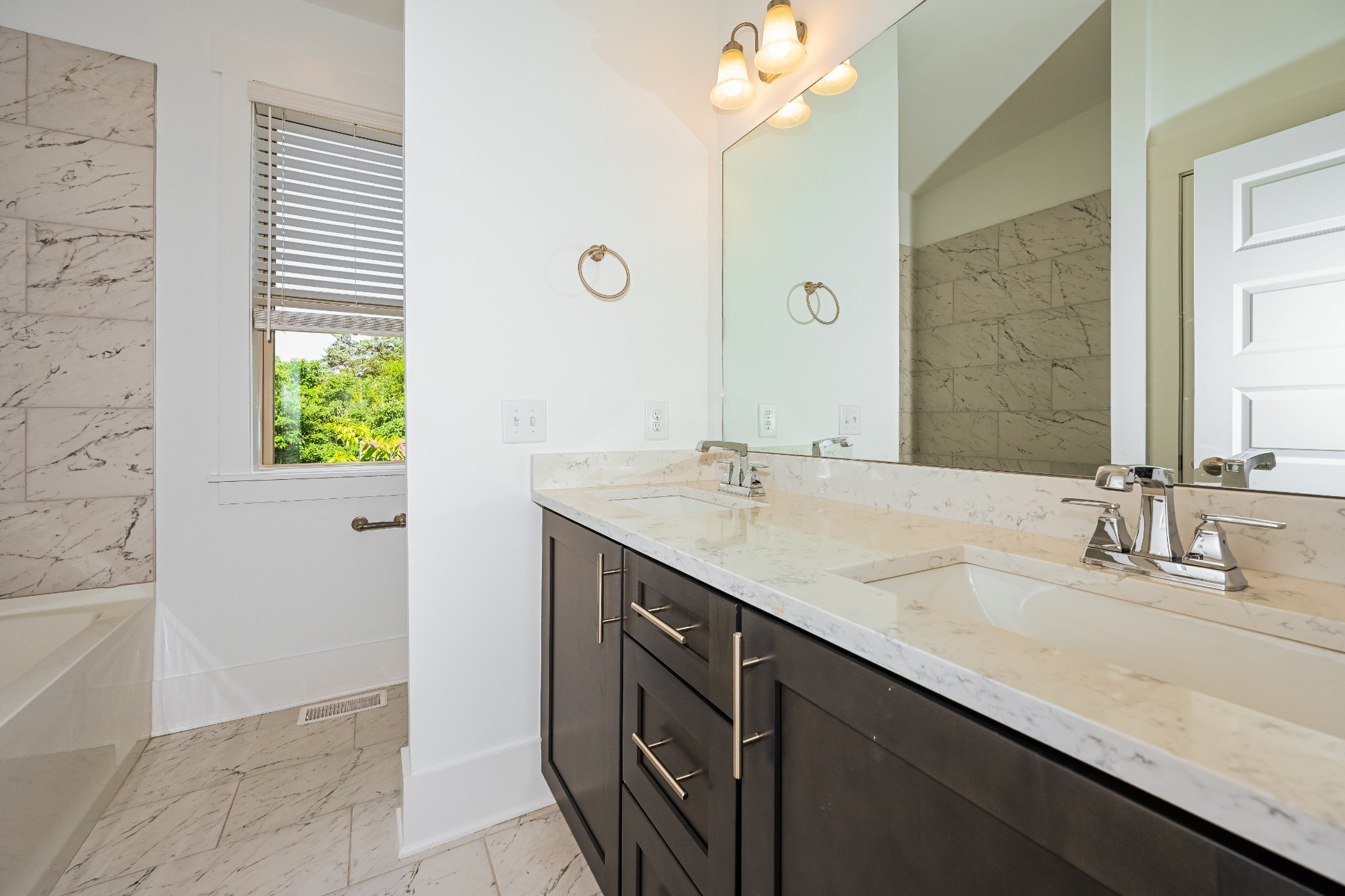 341 Edwin Street, Unit B Nashville, TN 37207 - Photo 7 of 17 a bathroom with a granite countertop sink and a mirror