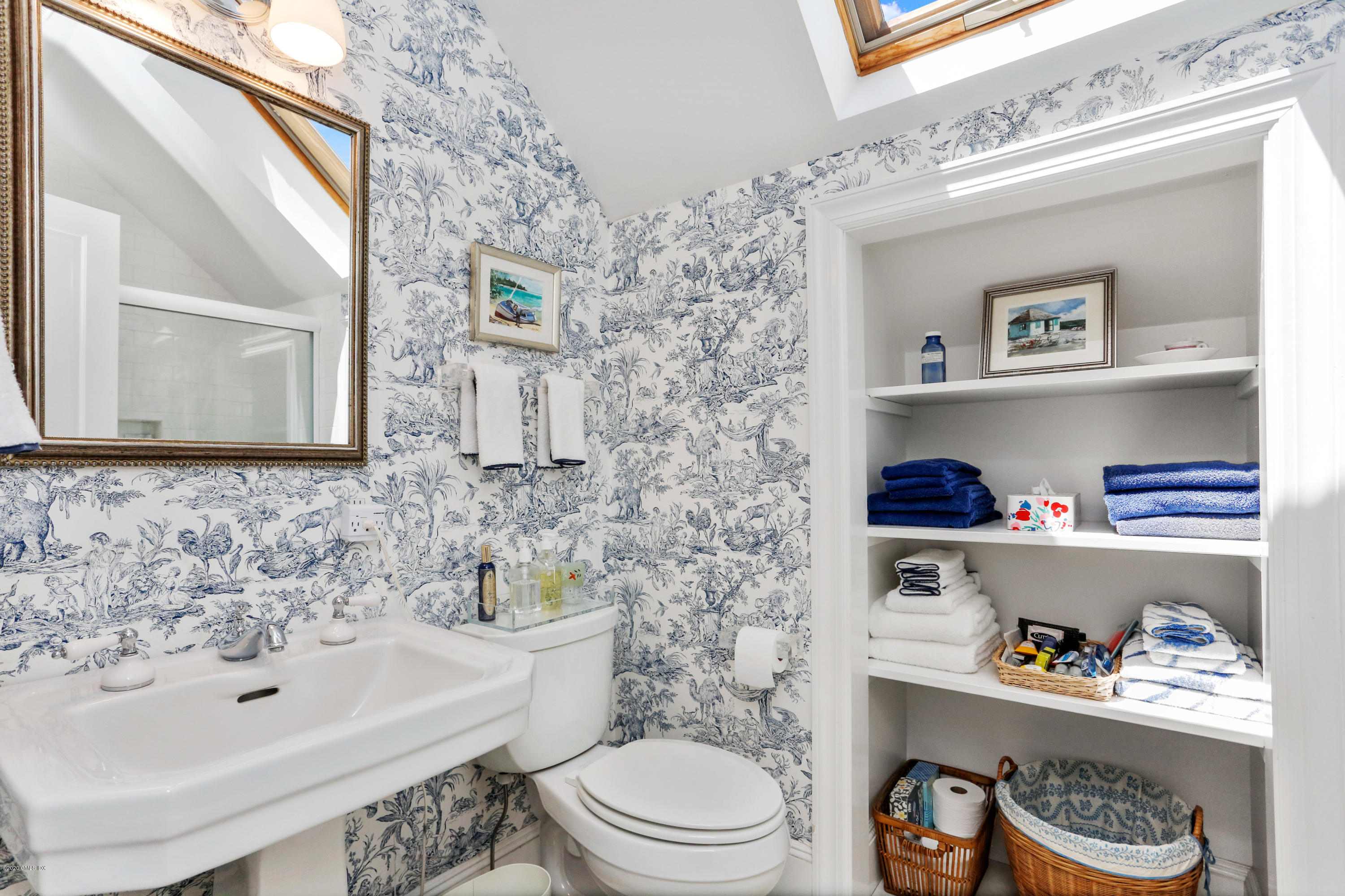 619 Steamboat Road Greenwich, CT 06830 - Photo 15 of 27 a bathroom with a sink a toilet and a mirror