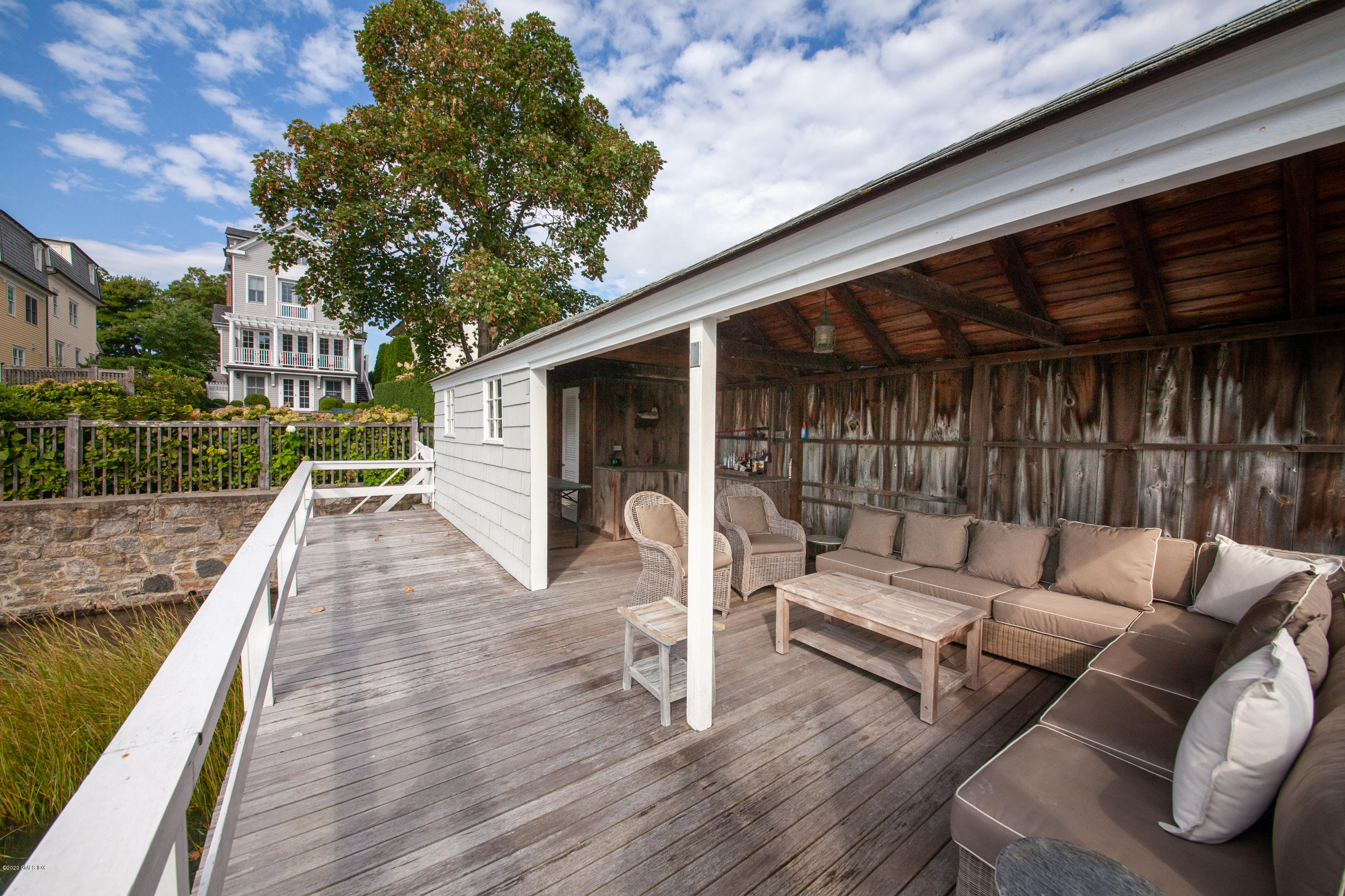 619 Steamboat Road Greenwich, CT 06830 - Photo 19 of 27 a view of a patio with couches table and chairs with wooden floor