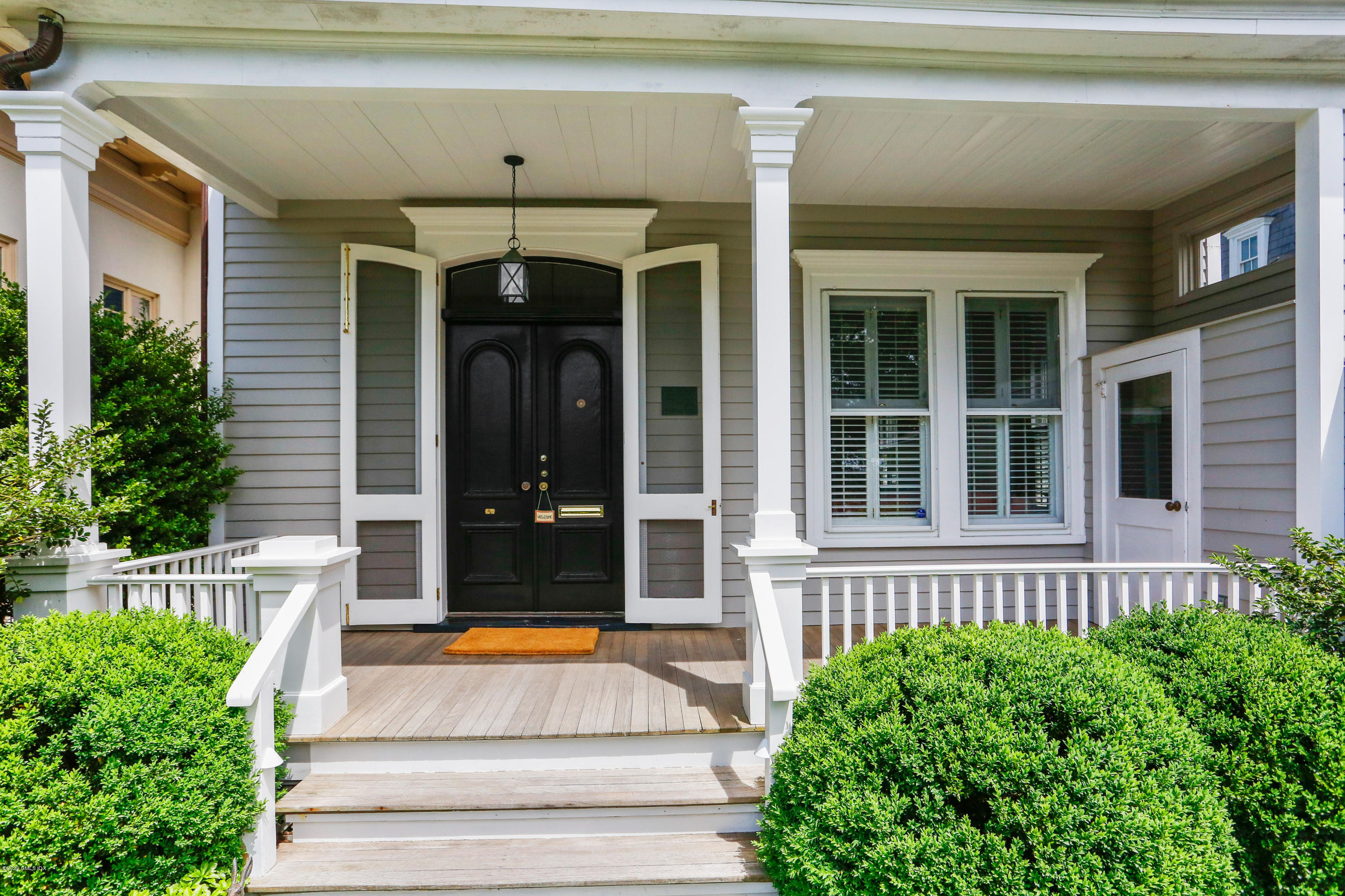 619 Steamboat Road Greenwich, CT 06830 - Photo 3 of 27 a front view of a house with a garden