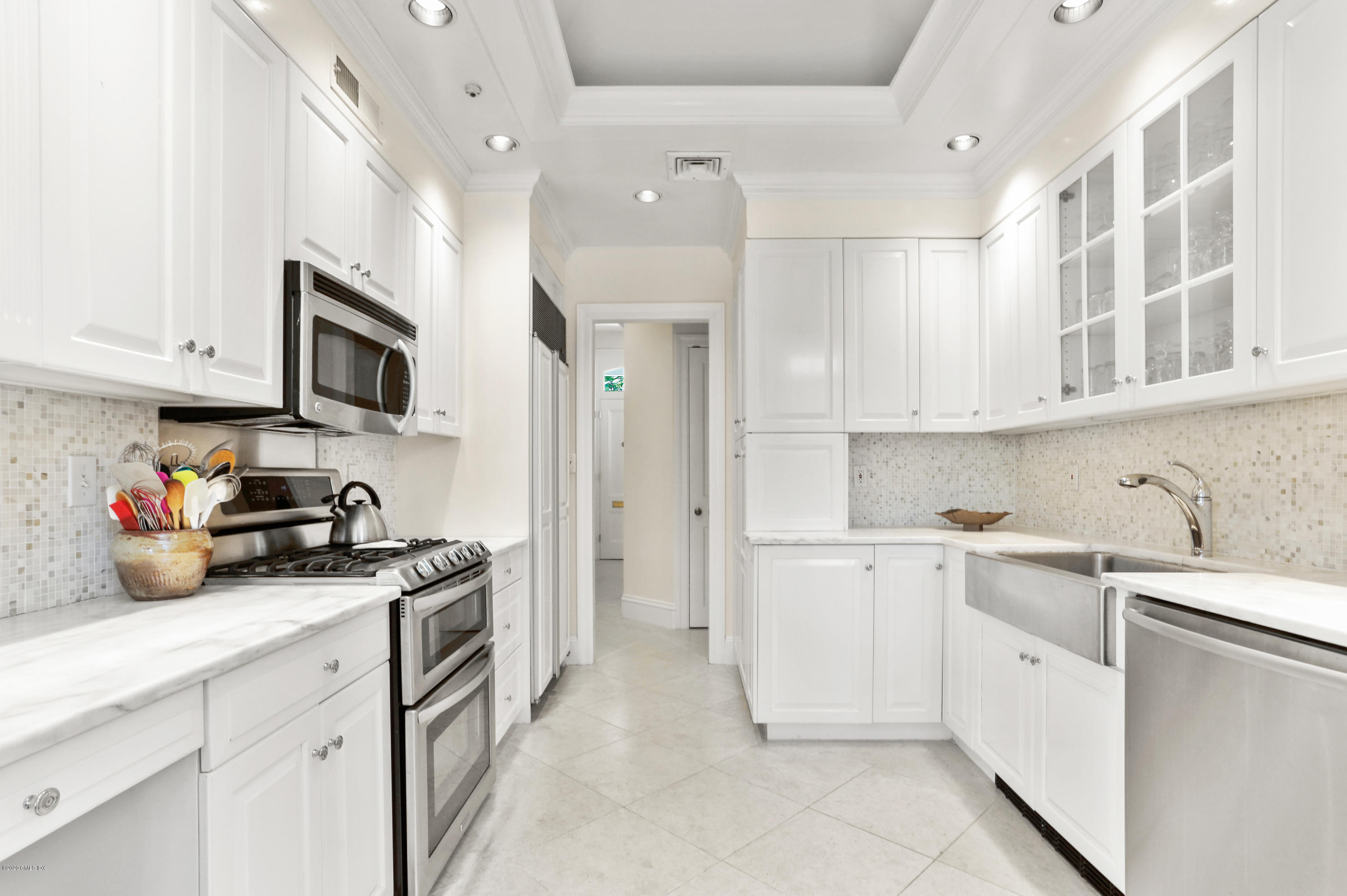 619 Steamboat Road Greenwich, CT 06830 - Photo 6 of 27 a kitchen with stainless steel appliances granite countertop a sink and dishwasher a stove top oven with white cabinets