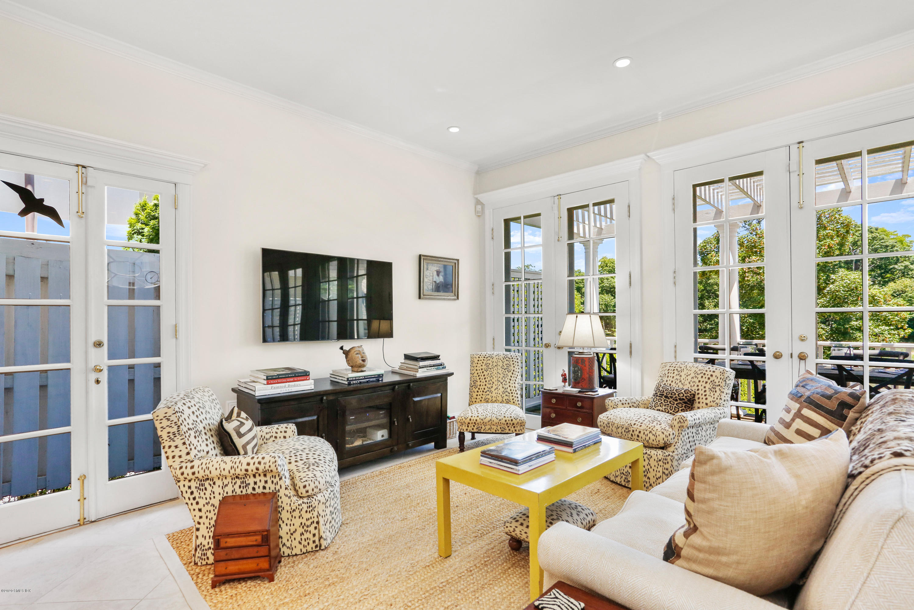 619 Steamboat Road Greenwich, CT 06830 - Photo 9 of 27 a living room with furniture and floor to ceiling windows