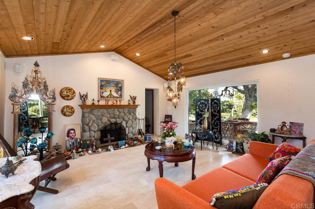 1249 Melba Road Encinitas, CA 92024 - Photo 13 of 47 a living room with patio furniture and a fireplace