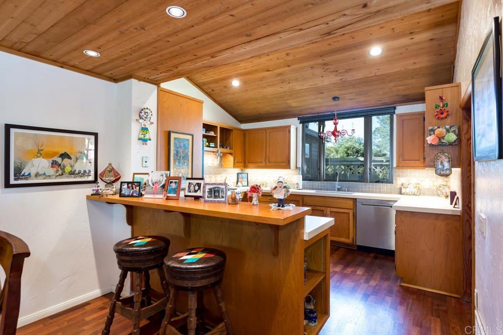 1249 Melba Road Encinitas, CA 92024 - Photo 18 of 47 a kitchen with a sink a cabinets and chairs