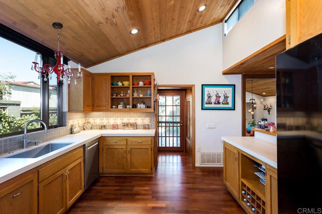 1249 Melba Road Encinitas, CA 92024 - Photo 25 of 47 a large kitchen with stainless steel appliances kitchen island granite countertop a sink and cabinets