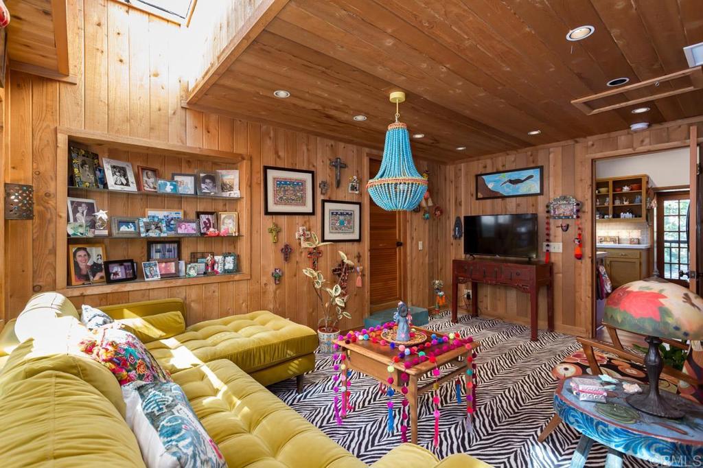 1249 Melba Road Encinitas, CA 92024 - Photo 27 of 47 a living room with furniture a rug and a chandelier