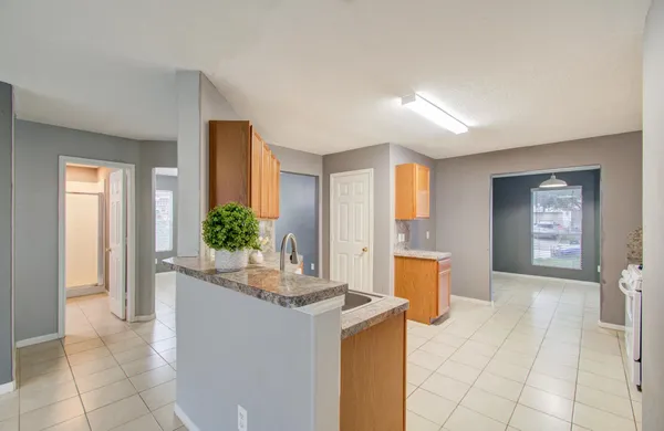 a room with a sink a table and chairs
