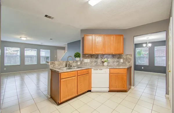 a kitchen with stainless steel appliances granite countertop a sink and cabinets