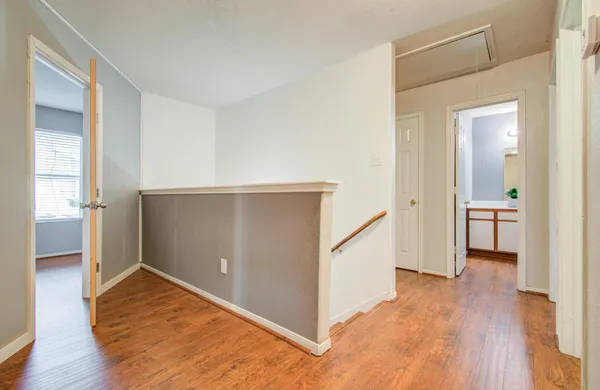 a view of a room with wooden floor and staircase