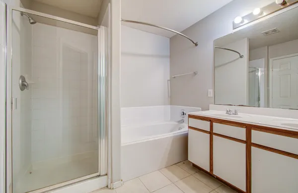 a bathroom with a bathtub and a shower