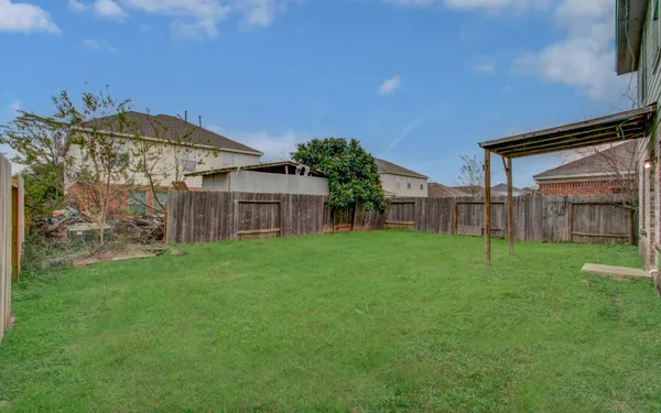 a view of a house with a backyard