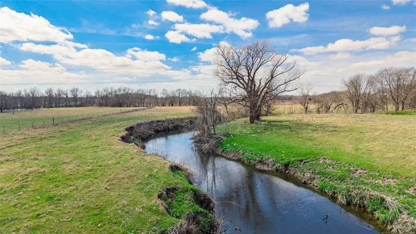 a view of a field with an ocean view