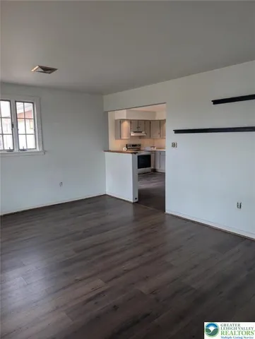 a view of a kitchen with wooden floor and electronic appliances