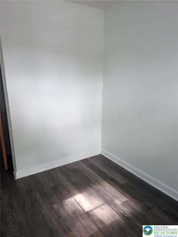 an empty room with wooden floor