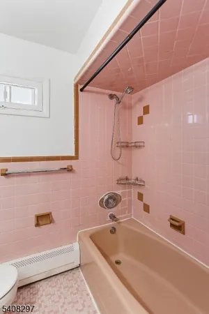 a bathroom with a tub and a sink