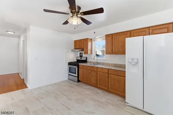 a kitchen with a refrigerator a sink and dishwasher