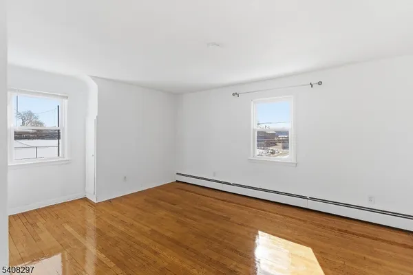a view of a room with a wooden floor and a window
