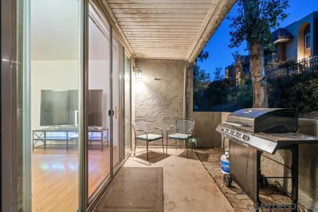 a view of a patio with table and chairs and potted plants