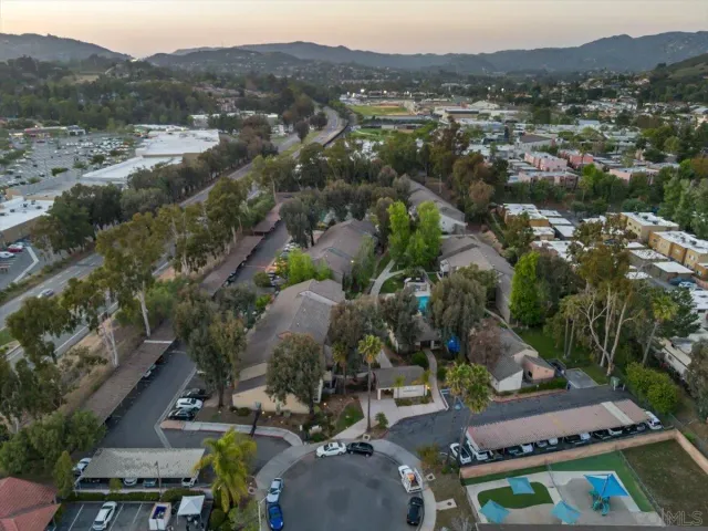an aerial view of house with yard swimming pool and mountain view