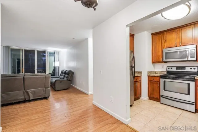 a kitchen with granite countertop a stove and a refrigerator