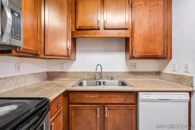 a kitchen with stainless steel appliances granite countertop a sink and cabinets