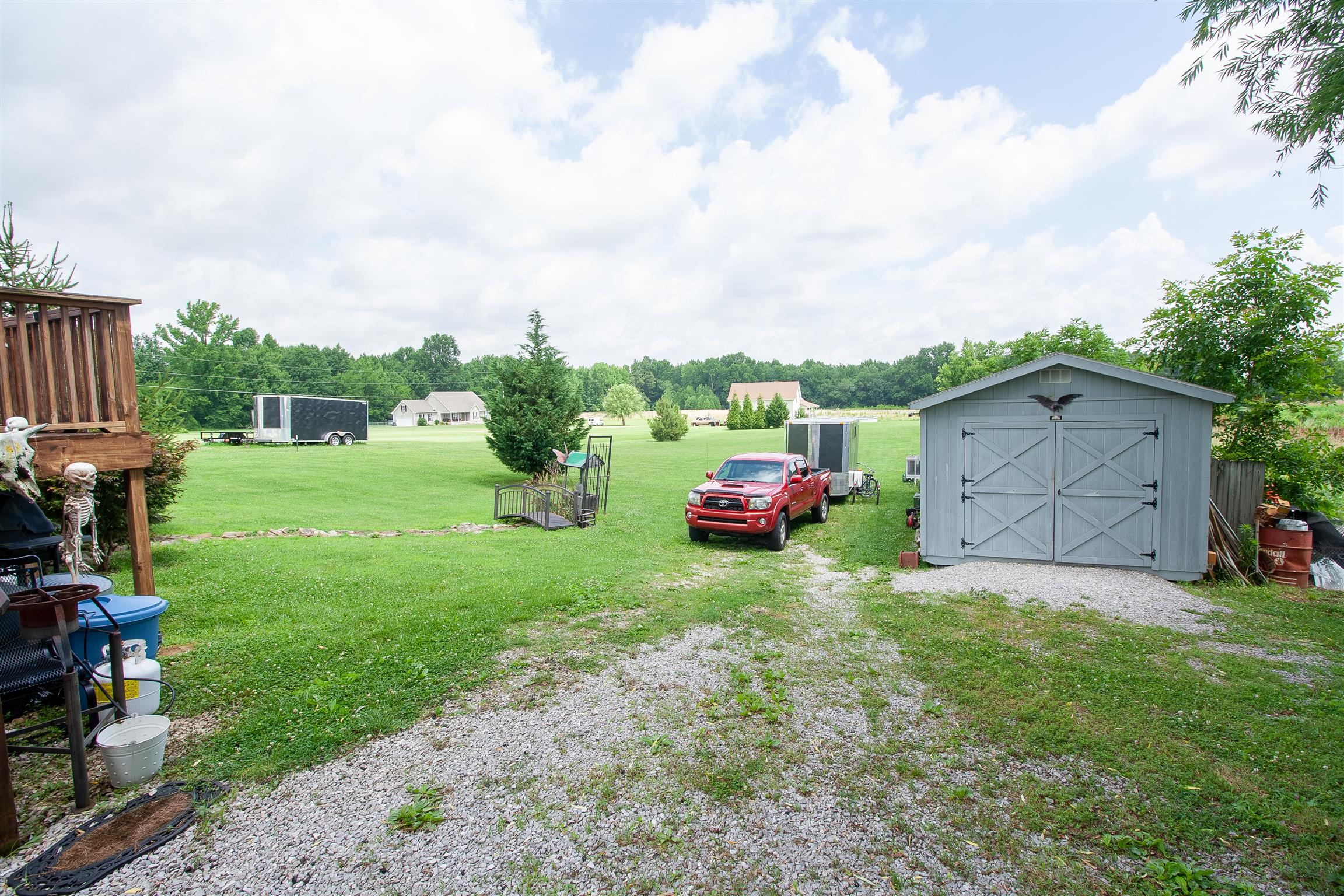 183 Shuab Road Portland, TN 37148 - Photo 5 of 25 a view of backyard with barbeque grill and a large tree