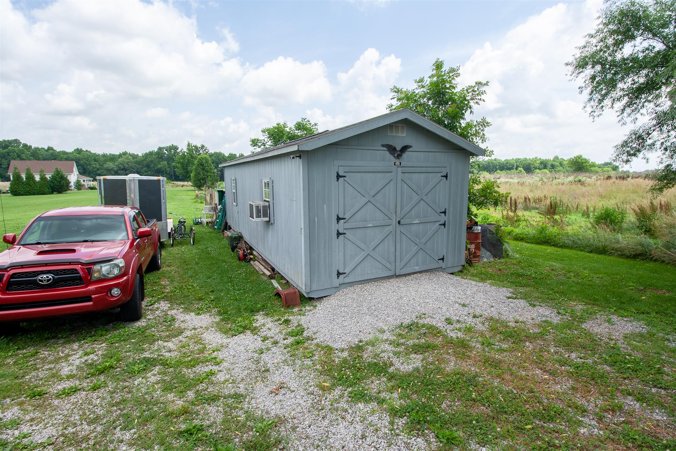 183 Shuab Road Portland, TN 37148 - Photo 9 of 25 a backyard of a house with a garden and barbeque oven