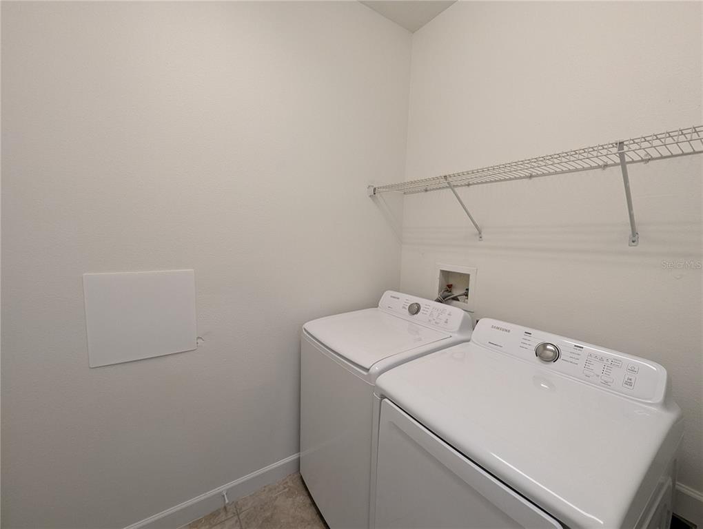 13428 Graham Yarden Drive Riverview, FL 33579 - Photo 12 of 15 a utility room with dryer and washer
