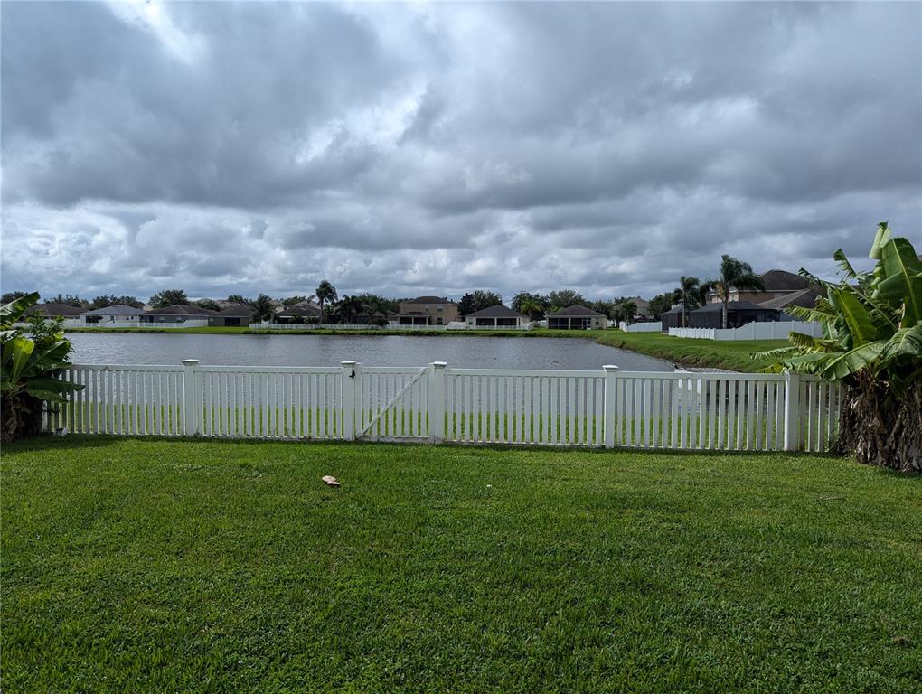 13428 Graham Yarden Drive Riverview, FL 33579 - Photo 14 of 15 a view of a yard with large trees and wooden fence