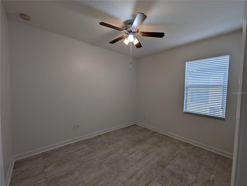 13428 Graham Yarden Drive Riverview, FL 33579 - Photo 9 of 15 an empty room with a window and a fan